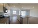 Modern kitchen with quartz countertops, stainless steel appliances, and a large island at 2690 E Abe Truckle Ave, San Tan Valley, AZ 85140