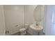 A powder room with modern fixtures, tile flooring and a pedestal sink at 2690 E Abe Truckle Ave, San Tan Valley, AZ 85140