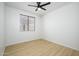 Simple bedroom with light wood floors and a window at 2732 W Lamar Rd, Phoenix, AZ 85017