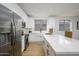 Updated kitchen featuring white cabinets, stainless steel appliances, and a large island at 2732 W Lamar Rd, Phoenix, AZ 85017