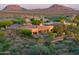 Luxury home nestled in the desert landscape with a private pool and mountain backdrop at 36578 N Boulder View Dr, Scottsdale, AZ 85262