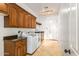 Bright laundry room with wood cabinets, granite countertops, and a large door at 36578 N Boulder View Dr, Scottsdale, AZ 85262