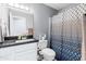 Clean bathroom with shower/tub, vanity, and patterned curtain at 3727 W Orangewood Ave, Phoenix, AZ 85051