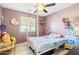 Bedroom with a canopy bed, and colorful decor at 3727 W Orangewood Ave, Phoenix, AZ 85051