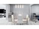 Bright dining area with glass table and four white chairs at 3727 W Orangewood Ave, Phoenix, AZ 85051