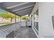 Covered front porch with tile flooring and wood accents at 3727 W Orangewood Ave, Phoenix, AZ 85051