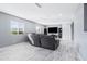 Spacious Gathering room with gray sectional sofa and large TV at 3727 W Orangewood Ave, Phoenix, AZ 85051