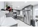 Modern kitchen with gray cabinets, stainless steel appliances, and quartz countertops at 3727 W Orangewood Ave, Phoenix, AZ 85051