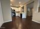 Modern kitchen featuring white cabinets, black appliances, and quartz countertops at 3865 E Santa Fe Ln, Gilbert, AZ 85297