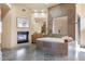 Luxurious bathroom with a large soaking tub and fireplace at 39816 N 106Th Pl, Scottsdale, AZ 85262