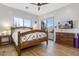 Bright bedroom with wooden bed frame and access to patio at 39816 N 106Th Pl, Scottsdale, AZ 85262