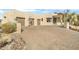 Front view of a beautiful home with a large driveway and basketball court at 39816 N 106Th Pl, Scottsdale, AZ 85262