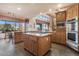 Spacious kitchen with island, granite countertops, and stainless steel appliances at 39816 N 106Th Pl, Scottsdale, AZ 85262