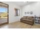 Cozy office space with brown couch and built-in bookcases at 39816 N 106Th Pl, Scottsdale, AZ 85262