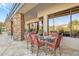 Covered patio with stone columns, seating area, and scenic views at 39816 N 106Th Pl, Scottsdale, AZ 85262