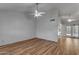 Bright living room with light wood floors and ceiling fan at 4556 N 88Th Ave, Phoenix, AZ 85037