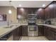 Modern kitchen with dark wood cabinets and stainless steel appliances at 5450 E Deer Valley Dr # 2191, Phoenix, AZ 85054