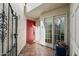 Inviting entryway with a red door, decorative gate, and tiled flooring at 5758 N 25Th St, Phoenix, AZ 85016