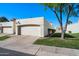 Attached garage with driveway, landscaping, and a view of neighboring homes at 5758 N 25Th St, Phoenix, AZ 85016