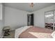 Well-lit bedroom with a queen bed, ensuite bathroom access, and a closet with geometric door at 8349 E Columbus Ave, Scottsdale, AZ 85251