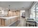 Open concept kitchen with island, light wood cabinets, and quartz countertops at 8349 E Columbus Ave, Scottsdale, AZ 85251