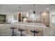 Modern kitchen with light wood cabinets, a large island, and stylish pendant lighting at 8349 E Columbus Ave, Scottsdale, AZ 85251
