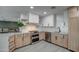Modern kitchen with light wood cabinets, stainless steel appliances, and white backsplash at 8349 E Columbus Ave, Scottsdale, AZ 85251