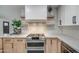 Modern kitchen with stainless steel appliances and light wood cabinets at 8349 E Columbus Ave, Scottsdale, AZ 85251