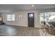 Open living area with hardwood floors, large windows, and a modern front door at 8349 E Columbus Ave, Scottsdale, AZ 85251