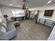 Bright living room featuring a gray sectional couch, luxury vinyl plank flooring and modern decor at 8349 E Columbus Ave, Scottsdale, AZ 85251