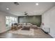 Living room with L-shaped sofa and geometric accent wall at 8349 E Columbus Ave, Scottsdale, AZ 85251