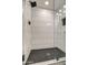 Modern shower with hexagon tile floor and subway tile walls at 8349 E Columbus Ave, Scottsdale, AZ 85251