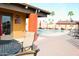 Community pool area with lounge chairs, palm trees, and tables with chairs at 9333 E University Dr # 196, Mesa, AZ 85207
