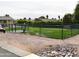 Fenced dog park featuring manicured grass, waste disposal, and double gated entry at 9333 E University Dr # 196, Mesa, AZ 85207