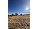 Flat lot with dry grass and distant homes at 966 S Warren Rd, Maricopa, AZ 85139