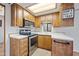 Small kitchen with wood cabinets and stainless steel appliances at 977 S Oxide Dr # 977, Apache Junction, AZ 85119