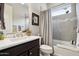 Clean bathroom with dark vanity, bathtub, and updated fixtures at 13443 W Blackstone Ln, Peoria, AZ 85383