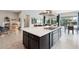 Modern kitchen with large island, stainless steel appliances, and dark cabinetry at 13443 W Blackstone Ln, Peoria, AZ 85383