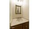 Clean bathroom with a vanity and a framed mirror at 1402 E Osborn Rd # 7, Phoenix, AZ 85014