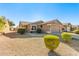 Tan house with a two-car garage and desert landscaping at 1403 E Cherry Hills Dr, Chandler, AZ 85249