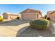 Tan house with a two-car garage and gravel driveway at 1403 E Cherry Hills Dr, Chandler, AZ 85249