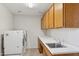 Laundry room with washer, dryer, and cabinets at 15433 W Cheery Lynn Rd, Goodyear, AZ 85395