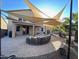 Spacious backyard patio perfect for entertaining, with shade sails and comfortable seating at 15936 W Canterbury Dr, Surprise, AZ 85379