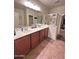Double vanity bathroom with a large shower at 15936 W Canterbury Dr, Surprise, AZ 85379