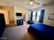 Bright bedroom with a comfortable bed, ample closet space, and large window at 15936 W Canterbury Dr, Surprise, AZ 85379