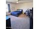 Spacious bedroom with a bed, workspace, and plenty of storage at 15936 W Canterbury Dr, Surprise, AZ 85379