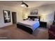 Spacious main bedroom with king-size bed and large mirror at 15936 W Canterbury Dr, Surprise, AZ 85379