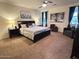 Main bedroom with a king-size bed and seating area at 15936 W Canterbury Dr, Surprise, AZ 85379