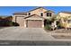 Two-story house with a three-car garage and landscaped front yard at 15936 W Canterbury Dr, Surprise, AZ 85379