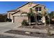 Two-story house with a three-car garage and landscaped front yard at 15936 W Canterbury Dr, Surprise, AZ 85379